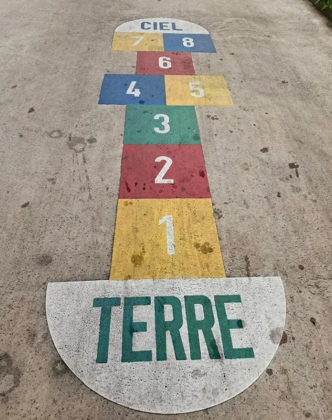 Hopscotch painted on the ground, from TERRE to CIEL